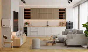 Nowoczesny salon z aneksem kuchennym. Jasne meble, wygodna sofa i funkcjonalna zabudowa kuchenna tworzą przytulną przestrzeń.