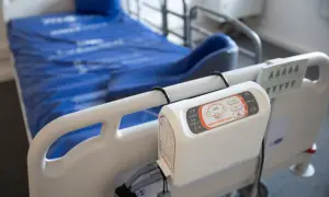Łóżko szpitalne z materacem przeciwodleżynowym i panelem sterowania. Dowiedz się, jak używać materaca przeciwodleżynowego, aby zapobiegać odleżynom.