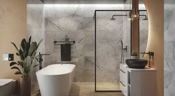 Nowoczesna łazienka z wolnostojącą wanną, prysznicem walk-in i umywalką nablatową. Zwraca uwagę elegancka wysokość wanny, idealnie dopasowana do reszty aranżacji.