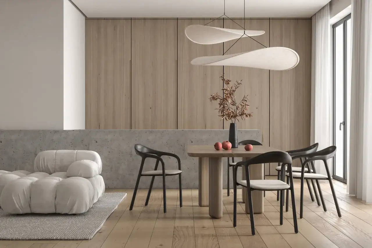 Minimalizm w domu: jasna kanapa, drewniany st&oacute;ł z krzesłami i ozdobna lampa tworzą przytulną atmosferę.